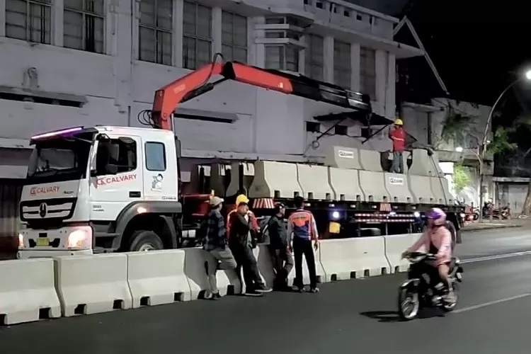 Pekerja Dishub Surabaya memasang barrier beton di Jalan Basuki Rahmat untuk menertibkan arus lalu lintas