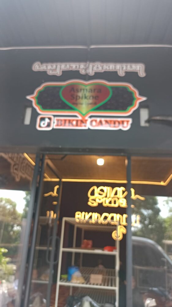 Tampak bagian depan gerai Roti Asmara Spikoe dengan papan nama dan logo usaha yang terpasang di atas etalase kaca.